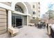 An elegant building entrance with dark doors, stone benches and railings, and comfortable seating area at 2499 Peachtree Ne Rd # 108, Atlanta, GA 30305