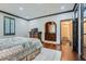 Comfortable main bedroom featuring hardwood floors, stylish trim, and built-in vanity area at 2499 Peachtree Ne Rd # 108, Atlanta, GA 30305
