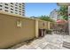 Private outdoor patio area featuring stone floors, wall planters, and a dining set under a red umbrella at 2499 Peachtree Ne Rd # 108, Atlanta, GA 30305
