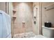 Tiled shower features glass door, multiple shower heads, and corner shelves for toiletries at 2499 Peachtree Ne Rd # 108, Atlanta, GA 30305