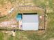 Aerial view of the barn and fenced perimeter on a large green pasture at 255 Henson Way, Canton, GA 30115