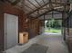 Interior of barn featuring enclosed stalls, a side door, and a view of the pasture at 255 Henson Way, Canton, GA 30115
