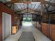 Barn interior with horse stalls and storage area with metal ceiling at 255 Henson Way, Canton, GA 30115