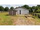 Exterior shot of barn and shed with fencing and grassy areas at 255 Henson Way, Canton, GA 30115