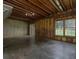 Unfinished basement space featuring concrete floors, exposed ceiling, and natural light through the windows at 255 Henson Way, Canton, GA 30115