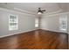 Spacious bedroom with hardwood floors, tray ceilings, and ample natural light from large windows at 255 Henson Way, Canton, GA 30115