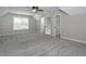 This bedroom features neutral walls, plush gray carpet, ceiling fan, and ample natural light from the window at 255 Henson Way, Canton, GA 30115