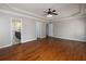 Open bedroom with gleaming floors, tray ceilings, ceiling fan and multiple entryways at 255 Henson Way, Canton, GA 30115