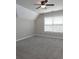 Spacious room featuring neutral walls, carpet, natural light, and a ceiling fan at 255 Henson Way, Canton, GA 30115