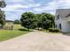 Extended driveway leading to a charming home, nestled amongst mature trees and manicured landscaping at 255 Henson Way, Canton, GA 30115