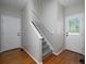 Inviting foyer featuring hardwood floors, staircase, and an abundance of natural light at 255 Henson Way, Canton, GA 30115