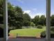 A picturesque view from the front porch, showcasing a lush lawn and white fencing at 255 Henson Way, Canton, GA 30115