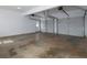 Spacious garage with white walls, room for two cars, and an access door to the side of the home at 255 Henson Way, Canton, GA 30115