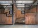 Horse stalls with metal and wood features with metal bars on top at 255 Henson Way, Canton, GA 30115