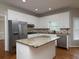 Modern kitchen features white cabinets, stainless appliances, and granite countertops at 255 Henson Way, Canton, GA 30115