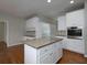 Bright kitchen featuring granite countertops, white cabinets, stainless oven, and hardwood floors at 255 Henson Way, Canton, GA 30115