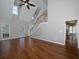 Spacious living room featuring hardwood floors, staircase, and lots of natural light at 255 Henson Way, Canton, GA 30115