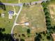 Aerial view of a property featuring a well maintained barn, home, and fenced pastureland at 255 Henson Way, Canton, GA 30115