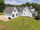 Rear view of a two-story home with a spacious backyard and patio area at 255 Henson Way, Canton, GA 30115