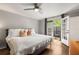 This bedroom features access to an outdoor patio, ceiling fan, and hardwood floors at 1140 Moorestown Cir, Decatur, GA 30033