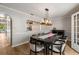 Formal dining room featuring modern lighting and a view into the kitchen at 1140 Moorestown Cir, Decatur, GA 30033