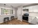 A modern kitchen features white cabinets, stainless steel appliances and new countertop at 1140 Moorestown Cir, Decatur, GA 30033