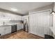 Modern kitchen featuring stainless steel appliances, white cabinets, and wood-look flooring at 1140 Moorestown Cir, Decatur, GA 30033