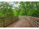 Scenic wooden walking trail meandering through a lush green forest at 1140 Moorestown Cir, Decatur, GA 30033