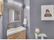 Stylish powder room featuring a modern vanity, gold accents, and decorative wall art at 1990 Cooper Lakes Dr, Grayson, GA 30017