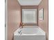 Comfortable bathtub nook with a stylish privacy window at 1990 Cooper Lakes Dr, Grayson, GA 30017