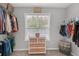 Spacious walk-in closet with ample storage and a sunny window at 1990 Cooper Lakes Dr, Grayson, GA 30017