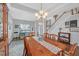 Well-lit dining space with hardwood floors, large table, adjacent study area, and staircase at 1990 Cooper Lakes Dr, Grayson, GA 30017