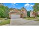 Charming home with attached garage, beautiful landscaping, and a spacious driveway at 1990 Cooper Lakes Dr, Grayson, GA 30017