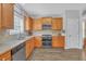Bright kitchen featuring modern appliances, wood cabinets, and tiled backsplash at 1990 Cooper Lakes Dr, Grayson, GA 30017