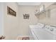 Functional laundry room with modern washer, dryer, and decorative wall signage at 1990 Cooper Lakes Dr, Grayson, GA 30017