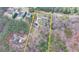 An aerial view outlining the property lines of a home nestled amongst towering trees, with views of the neighborhood at 2885 Green Rd, Loganville, GA 30052