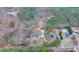 An aerial view of a home situated on a wooded lot, showcasing its serene and private location at 2885 Green Rd, Loganville, GA 30052