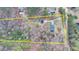 An aerial view outlining the property lines of a home with pond access in the distance, nestled among lush trees at 2885 Green Rd, Loganville, GA 30052