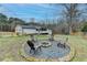 Expansive backyard with a custom fire pit and partial fence for privacy at 2885 Green Rd, Loganville, GA 30052