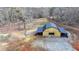 Aerial view of a bright wood barn, spacious lot with mature trees and partial perimeter fencing at 2885 Green Rd, Loganville, GA 30052