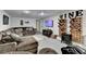 Basement living area featuring a sectional couch, mounted TV and custom wooden wine rack at 2885 Green Rd, Loganville, GA 30052
