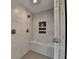 Tile shower features seating, shower head and built in shelving at 2885 Green Rd, Loganville, GA 30052