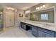 Bathroom features a large mirror, double vanity and walk in shower at 2885 Green Rd, Loganville, GA 30052