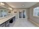 Spacious bathroom featuring double sinks, large mirror and french doors at 2885 Green Rd, Loganville, GA 30052