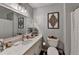 Neutral bathroom featuring a framed mirror, ornate decorations and a single-sink vanity with marble countertops at 2885 Green Rd, Loganville, GA 30052