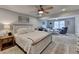 Spacious bedroom with a ceiling fan, carpet, and an adjacent sitting area at 2885 Green Rd, Loganville, GA 30052