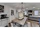Inviting dining area with wood table set for six, open to living area with stone fireplace at 2885 Green Rd, Loganville, GA 30052
