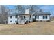 Charming exterior view of a two-story home with a well-maintained lawn and inviting front porch at 2885 Green Rd, Loganville, GA 30052