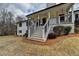Welcoming front porch with charming details, including a seating area and elegant black railings at 2885 Green Rd, Loganville, GA 30052