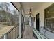 Cozy front porch featuring a comfortable bench, stylish lighting, and an inviting welcome sign at 2885 Green Rd, Loganville, GA 30052